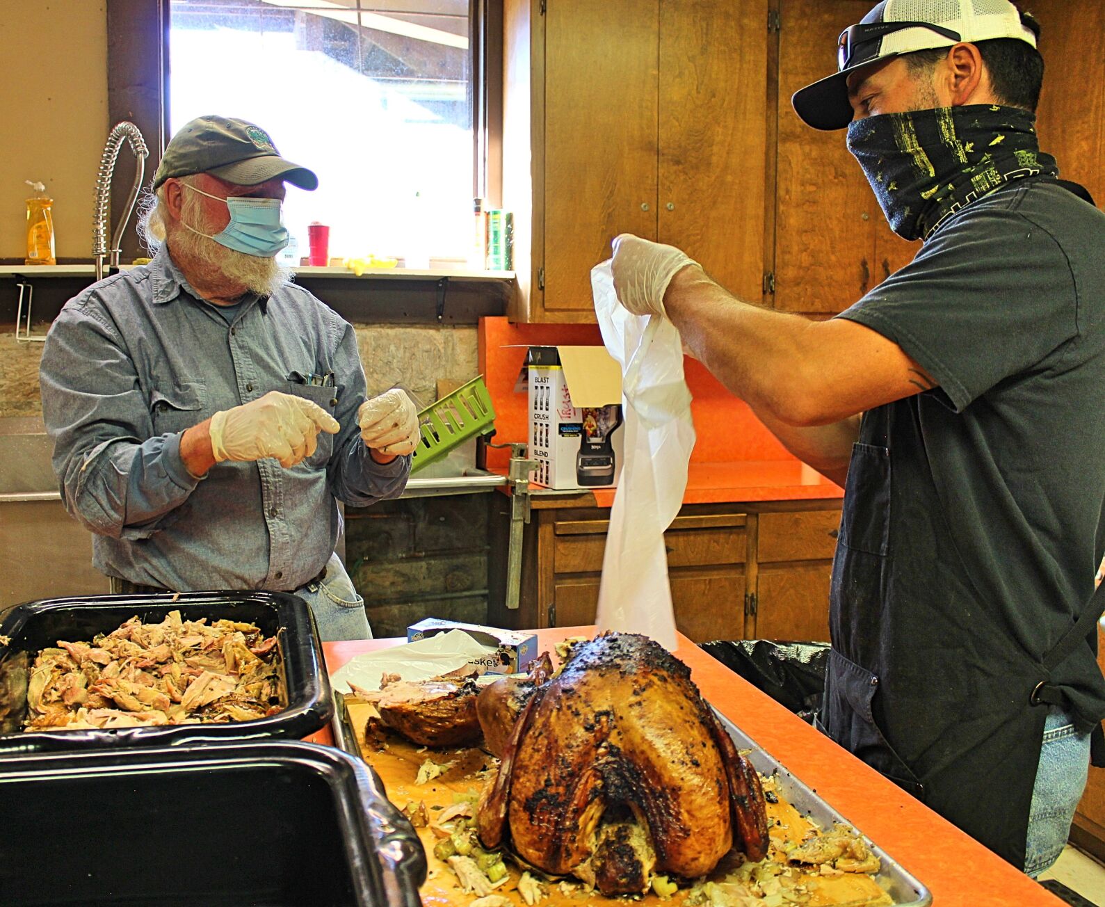 5. Volunteers carving up the birds, packing homemade gravy and cranberry sauce in to-go boxes. photo by Dave Gebauer..jpg